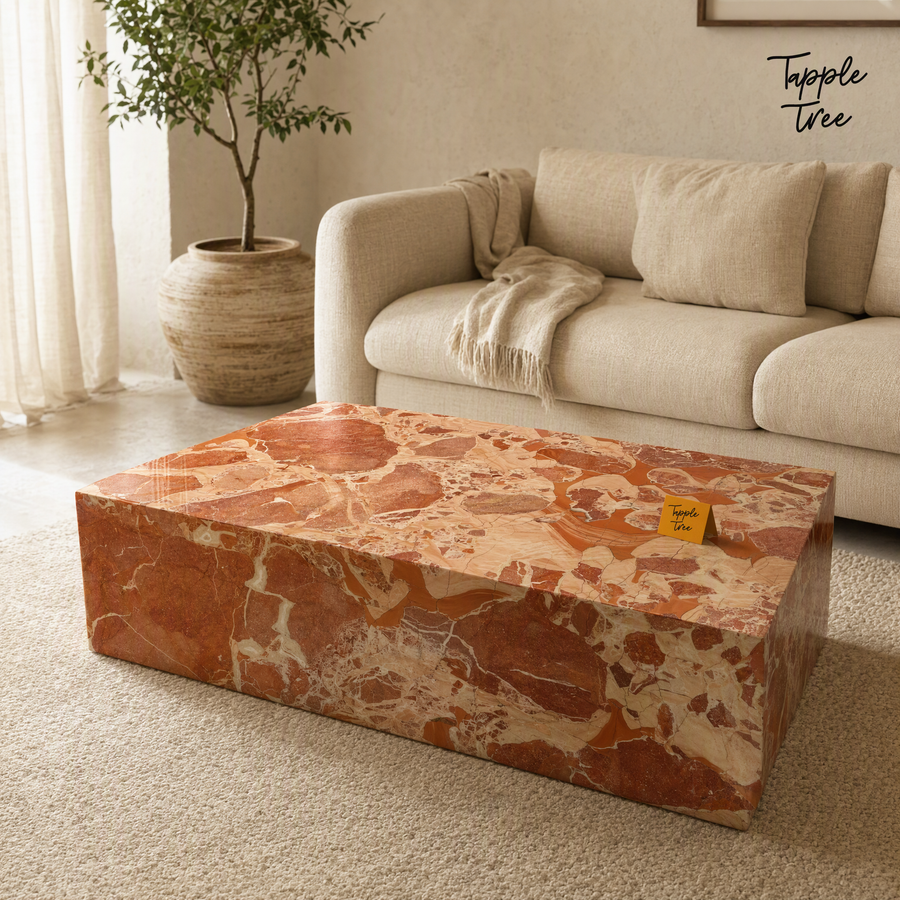 Imported stone coffee table with a glossy terracotta and cream surface in a neutral living room