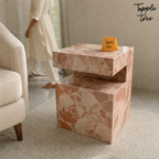 Imported stone side table — lifestyle walking woman; glossy terracotta and cream finish