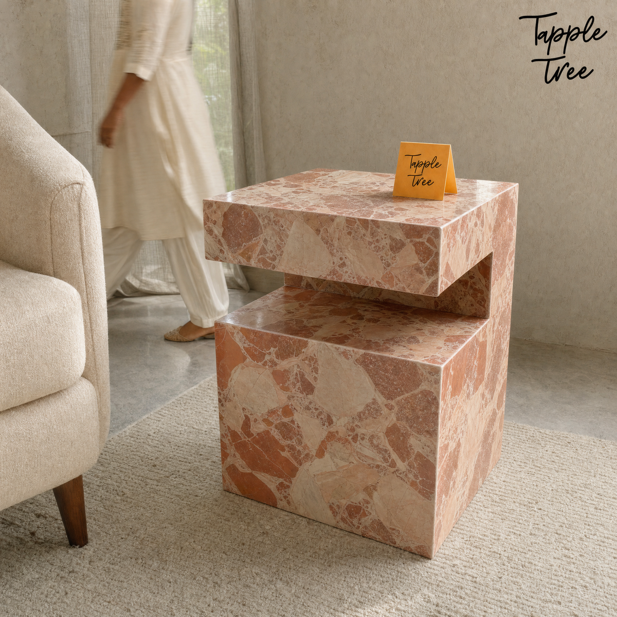 Imported stone side table — lifestyle walking woman; glossy terracotta and cream finish