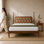 Botanical teak bed in a neutral bedroom with an Indian woman walking softly blurred at the edge