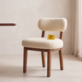 Dorian Meadow Bouclé Mango Wood Dining Chairs (Set of 2) in an Amber Solace finish, styled in a dining room