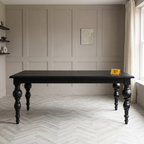 Noir Trestle Black Mango Wood 6-Seater Dining Table, front view in a dining room